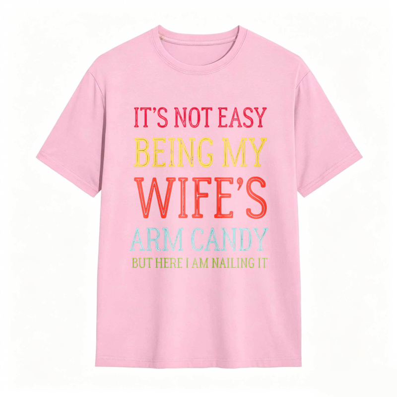 Dorawear™ Its Not Easy Being My Wifes Arm Candy But Here I Am Nailing It Unisex Classic T-shirt