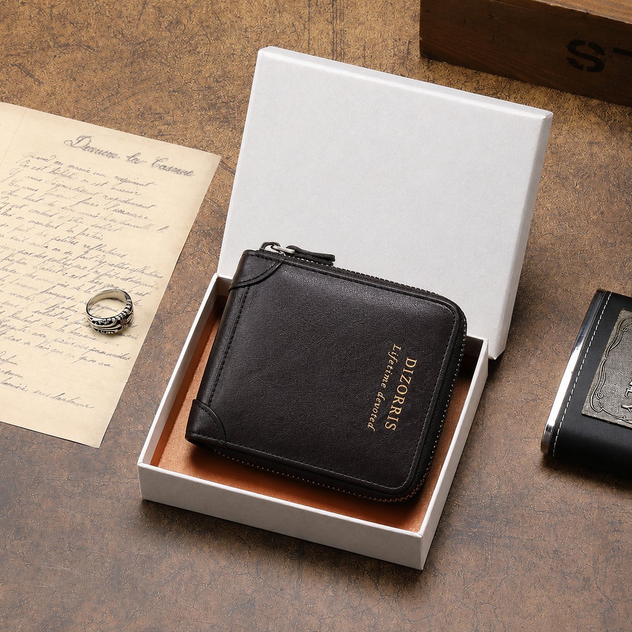 Black zip leather wallet displayed in an open presentation box
