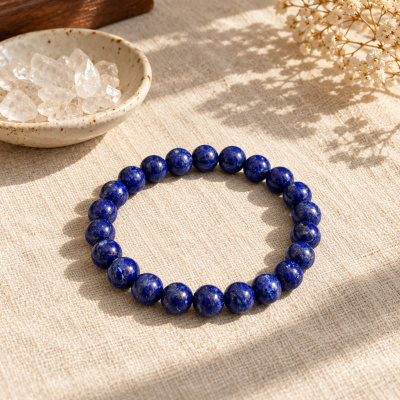 Lapis lazuli bracelet on linen beside clear quartz chips