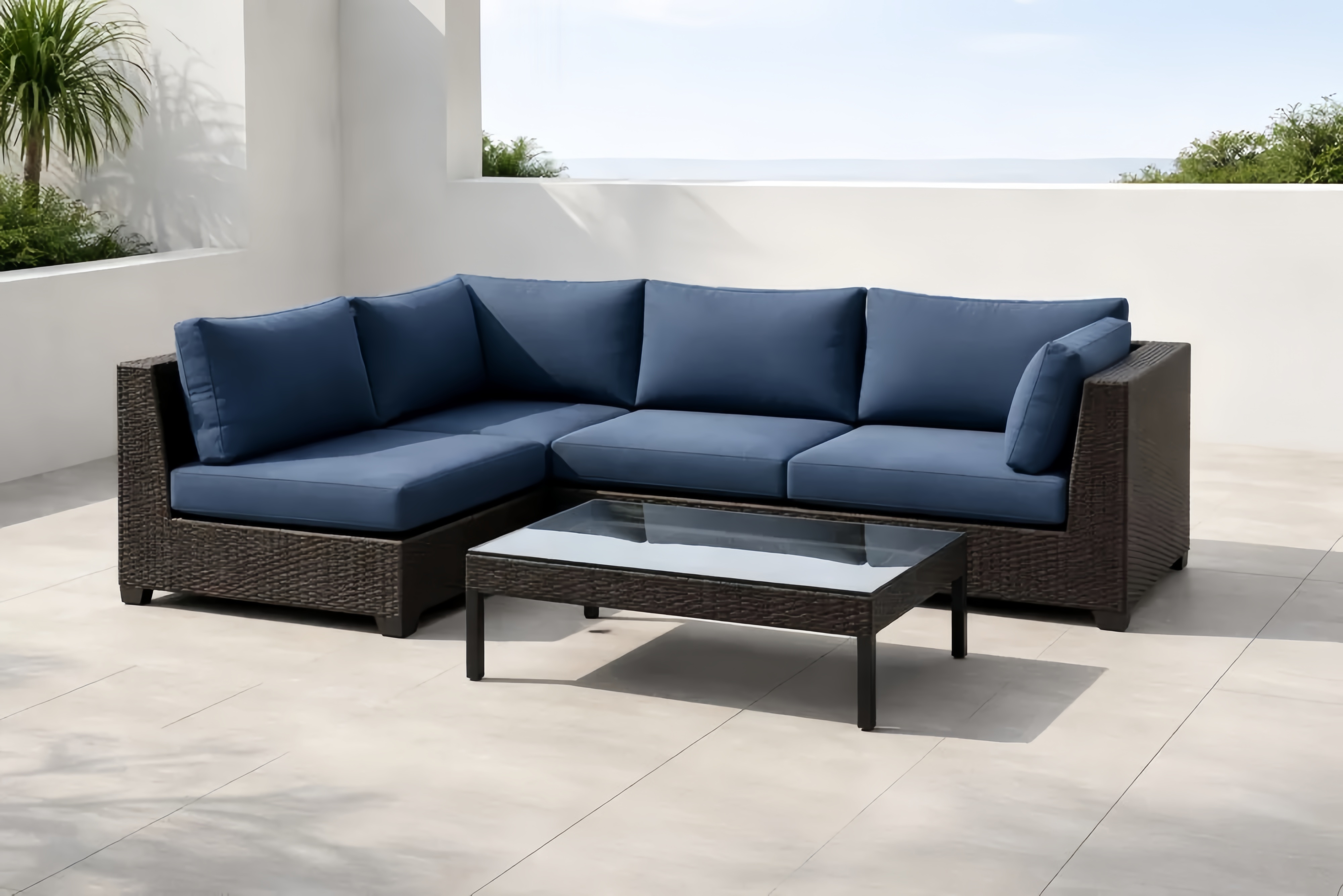 Set divano angolare da esterno in rattan con cuscini blu