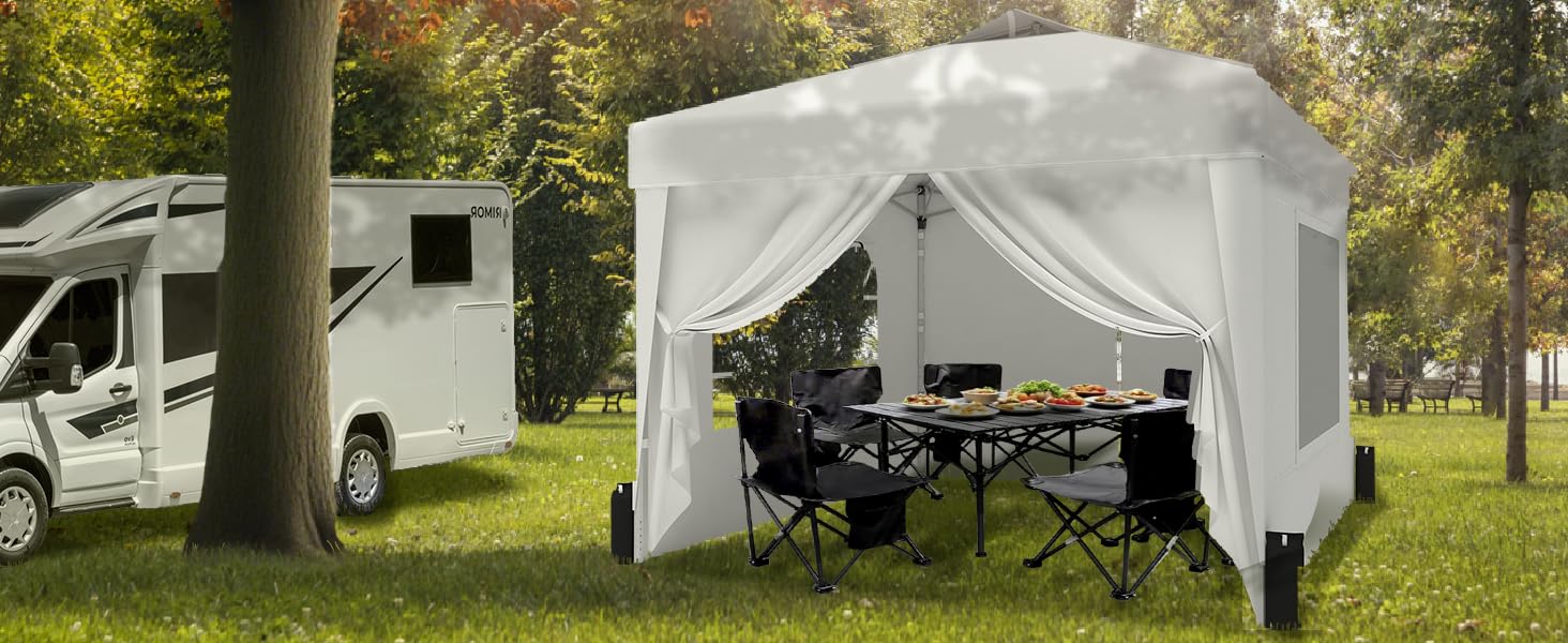 A couple is enjoying their breakfast in a tent beside the caravan.