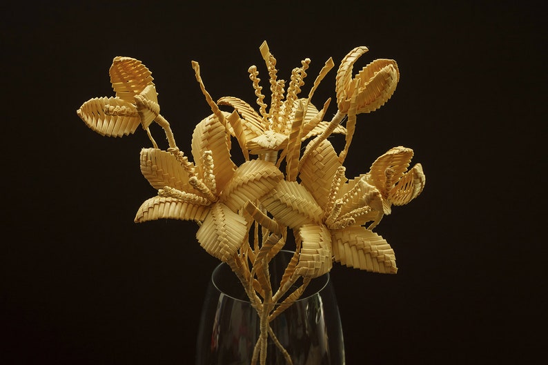 Natural straw woven bouquet, handmade rustic floral decoration.