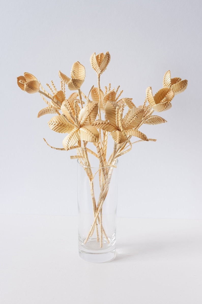 Natural straw woven bouquet, handmade rustic floral decoration.