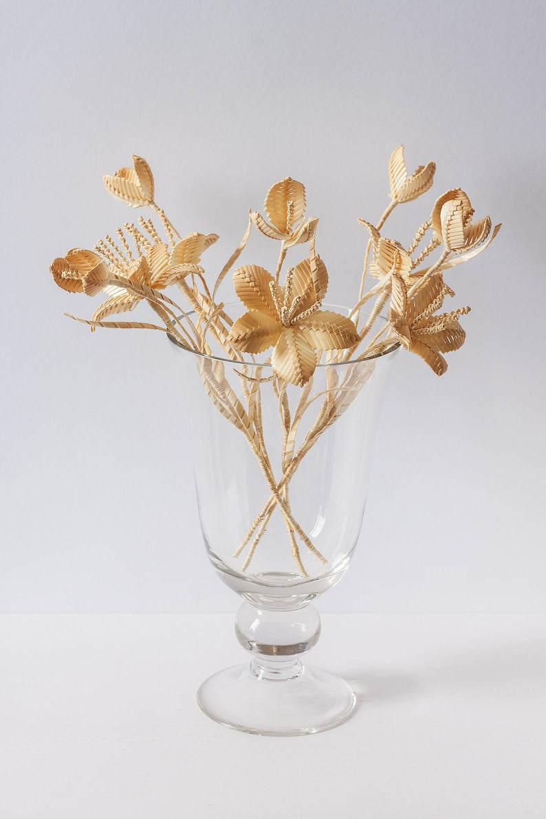 Natural straw woven bouquet, handmade rustic floral decoration.
