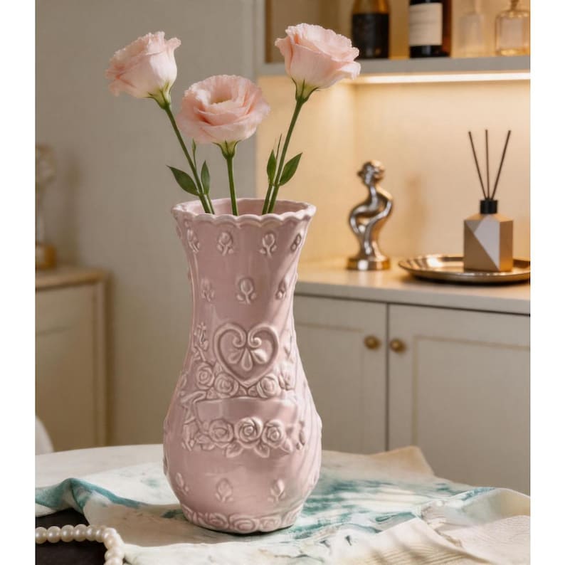 Pink ceramic Porcelain vase with embossed heart pattern and ruffled rim.
