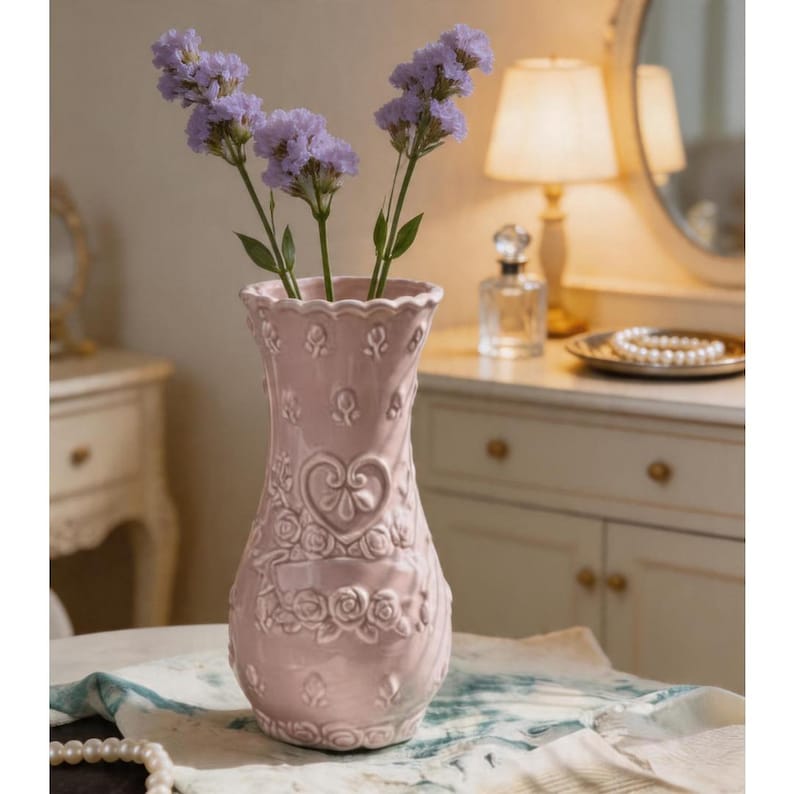 Pink ceramic Porcelain vase with embossed heart pattern and ruffled rim.