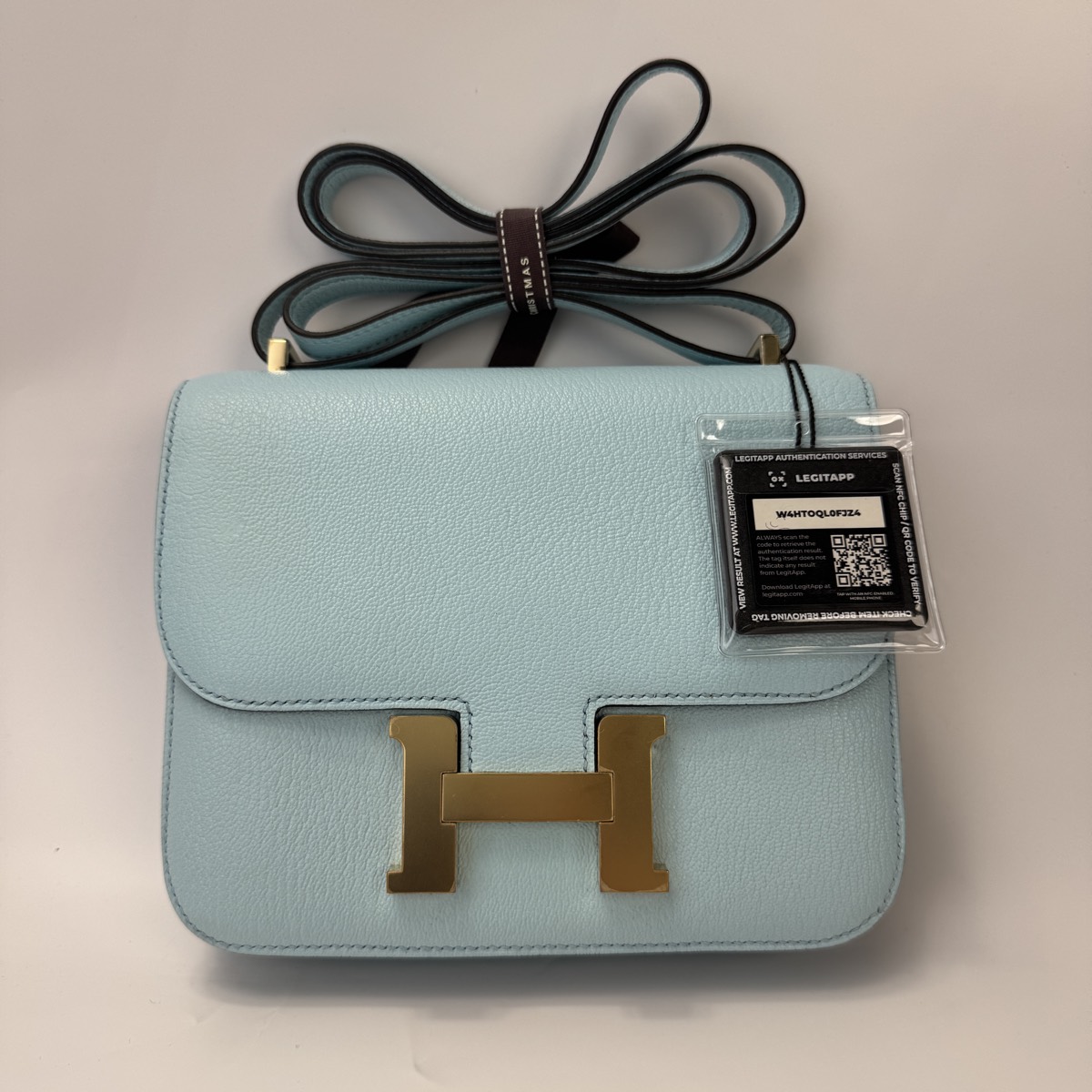 Authenticated luxury bag shipped with LegitApp security tag attached