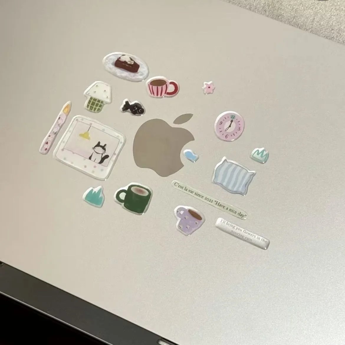 Kawaii stickers arranged around a laptop logo
