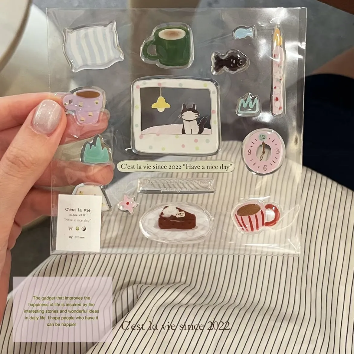Hand holding the glossy sticker sheet