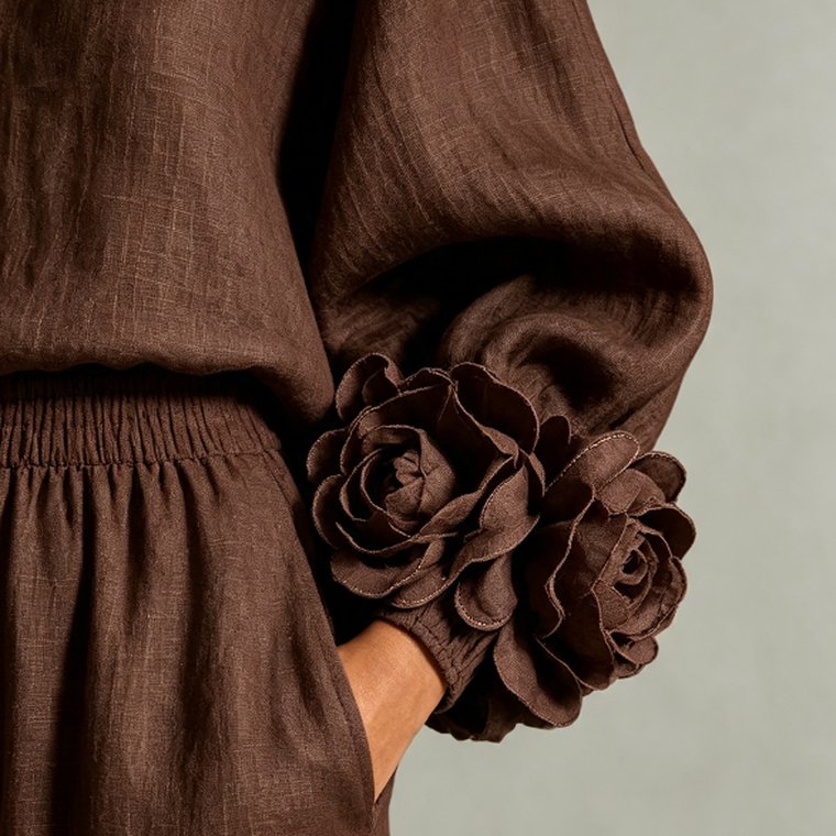 Close-up of the hand-stitched 3D camellia cuff in Chocolate, showing the rolled petal edges