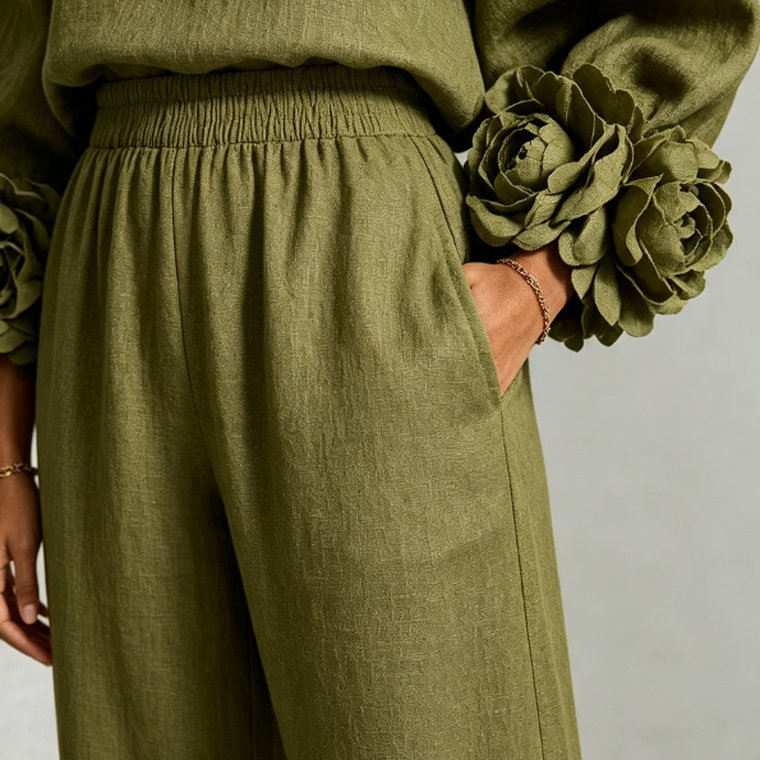 The camellia cuff in Olive, with a hand resting in the trouser pocket