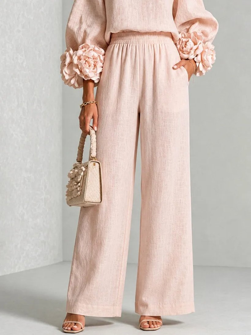 Detail of the wide-leg trousers: smocked elasticated waist and side pocket