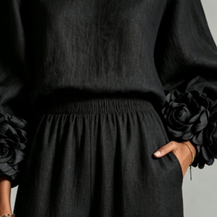 The Camellia Cuff Set in Black, hand resting in the trouser pocket