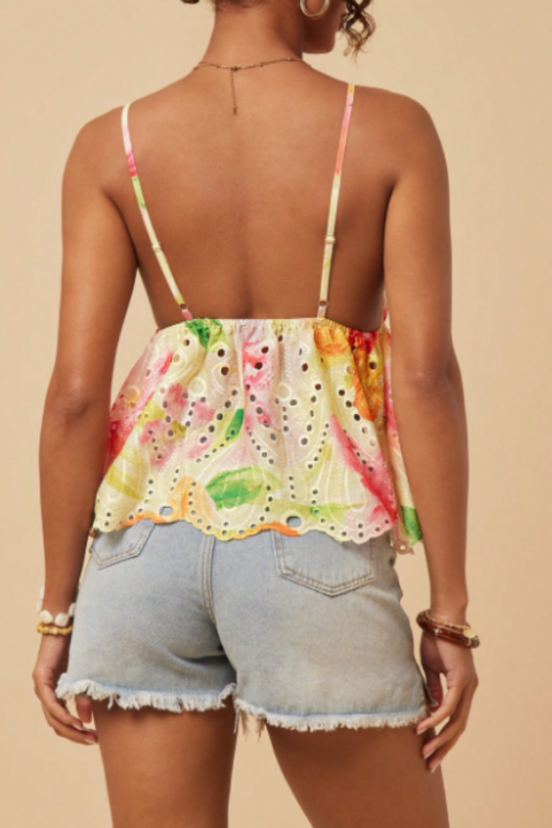 This bohemian-style camisole features a ruffled hem and is adorned with floral patterns, embroidery, and prints.