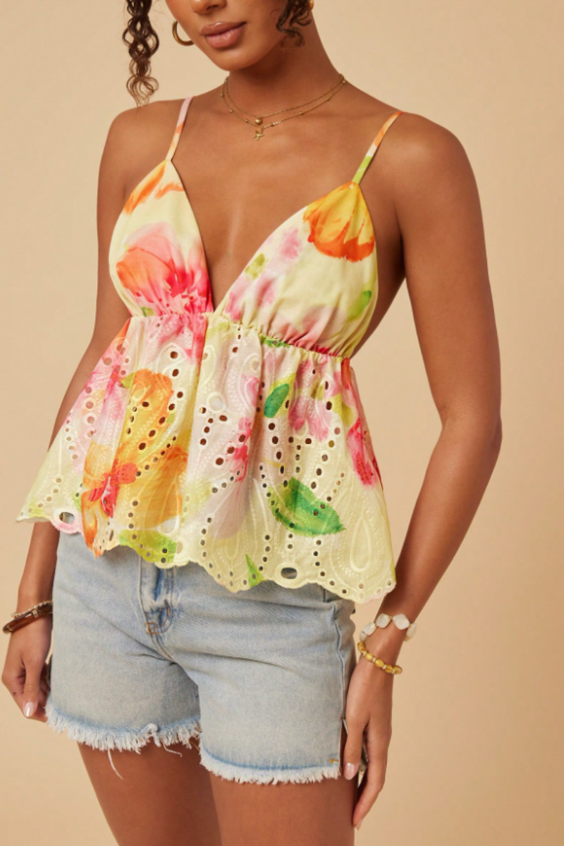 This bohemian-style camisole features a ruffled hem and is adorned with floral patterns, embroidery, and prints.
