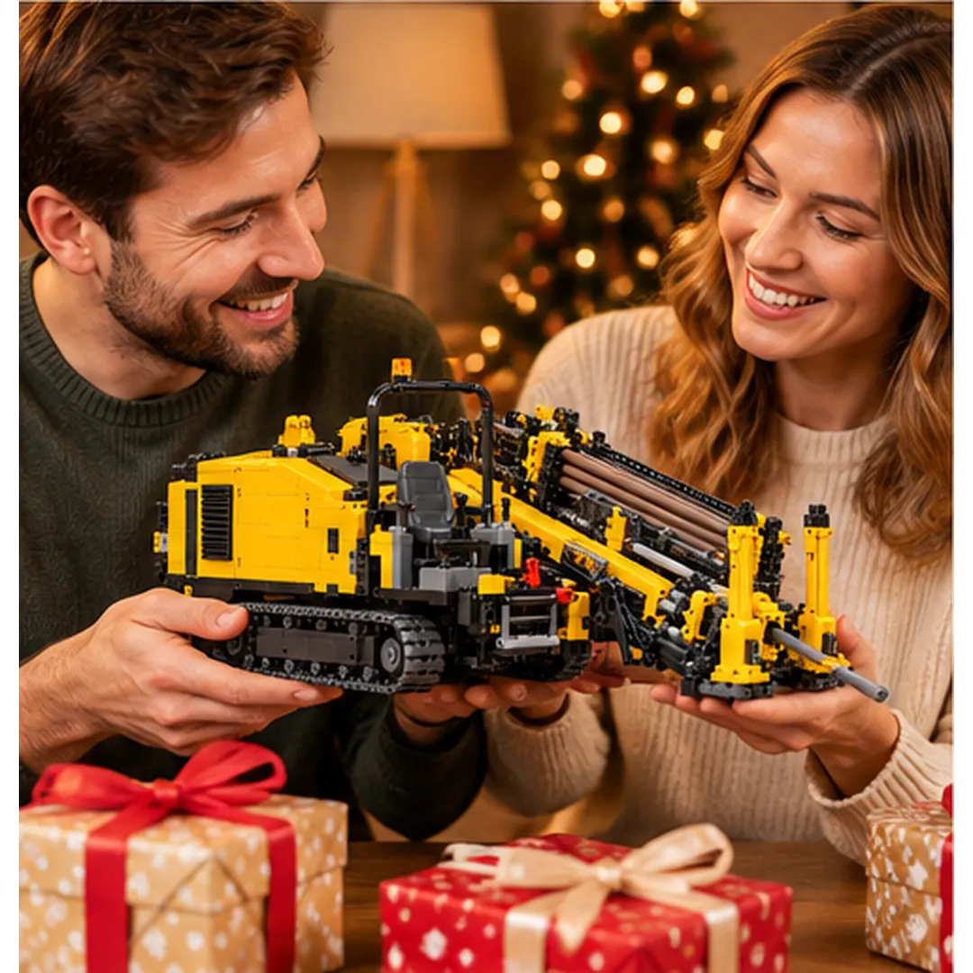 Smiling couple admiring a yellow horizontal directional drill collector brick-built model beside wrapped holiday gifts