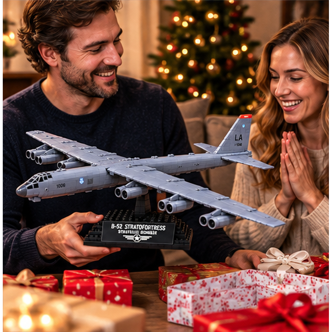 Couple enjoying the gift presentation of a gray B-52 Stratofortress collector brick bomber displayed on a black base beside Christmas presents