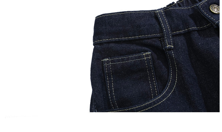 Close-up of dark blue jeans with stitching detail on a white background