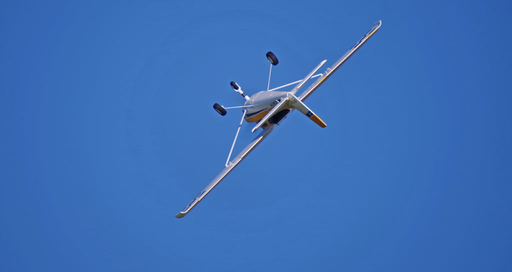 white remote control aircraft performing aerial maneuvers