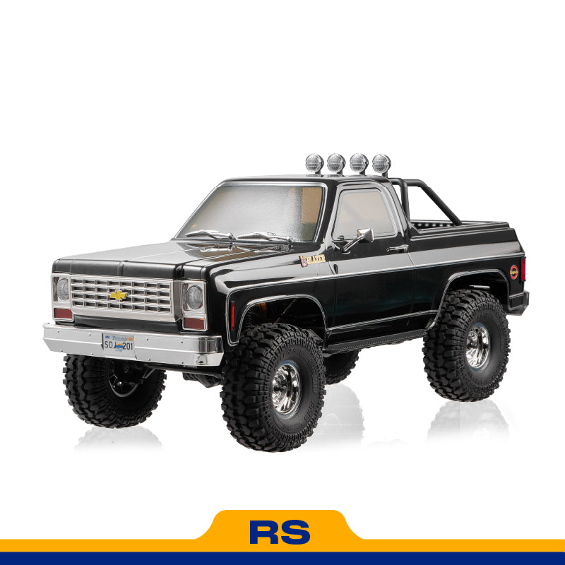 FMS 1:10 scale black Chevrolet K5 Blazer RS with off-road tires and roof lights.