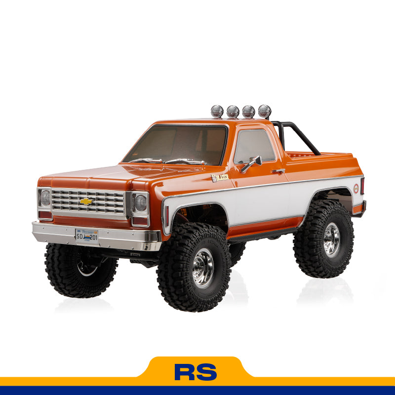 FMS 1:10 FCX10 Chevrolet K5 Blazer RS orange remote control truck with large tires and spotlights.