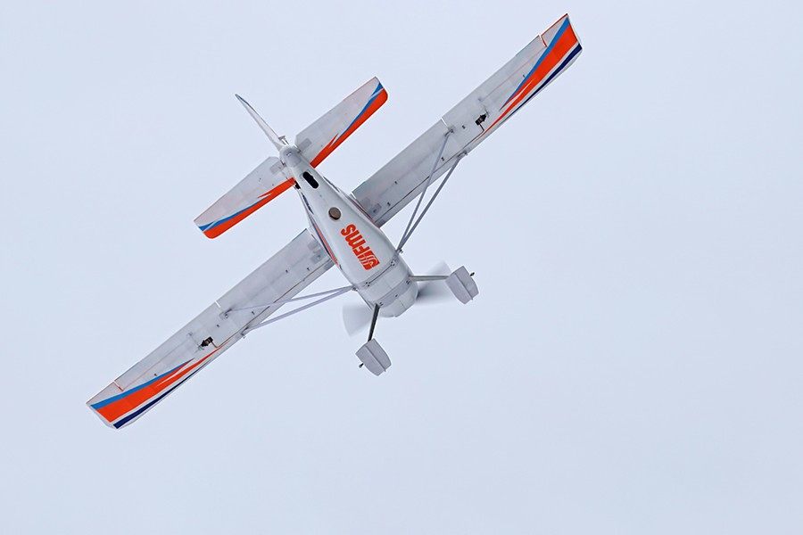 FMS 1400mm Kingfisher PNP airplane with orange and blue trim in flight