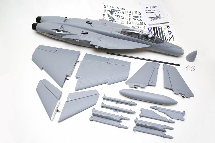 FMS 70mm F-18F V2 PNP model jet kit components, including fuselage, wings, tail fins, and missiles, with decals and manual.