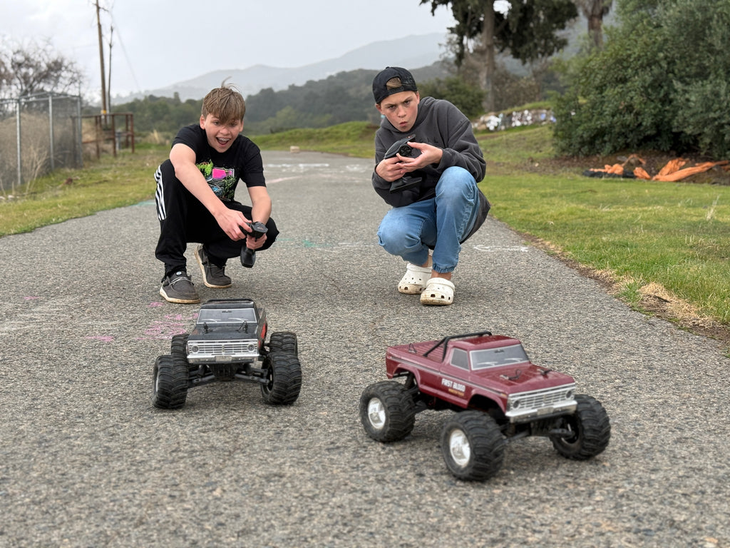 RC monster trucks racing on pavement