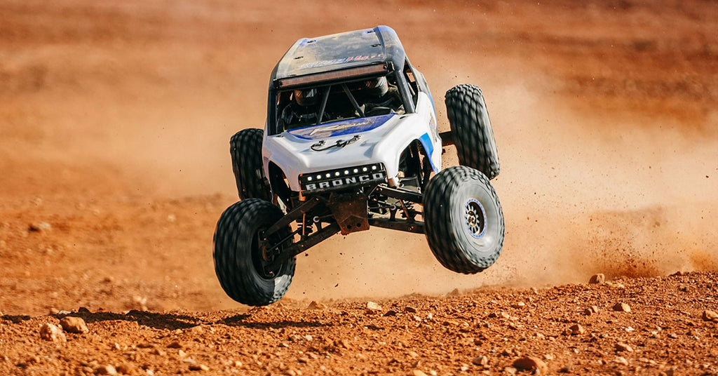 Bronco RC truck leaping over dirt mound