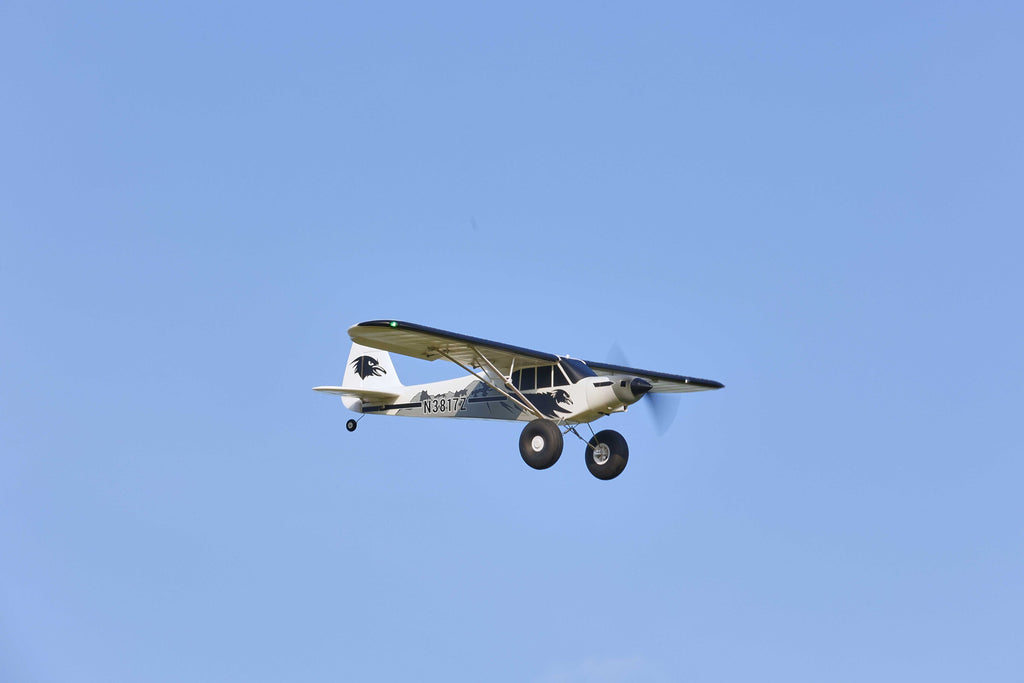 RC aircraft flying in ideal blue sky conditions