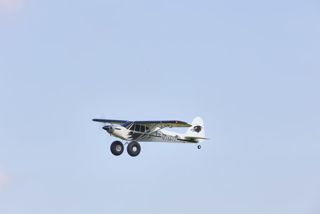 Fmshobby RC electric airplane banking in open blue sky