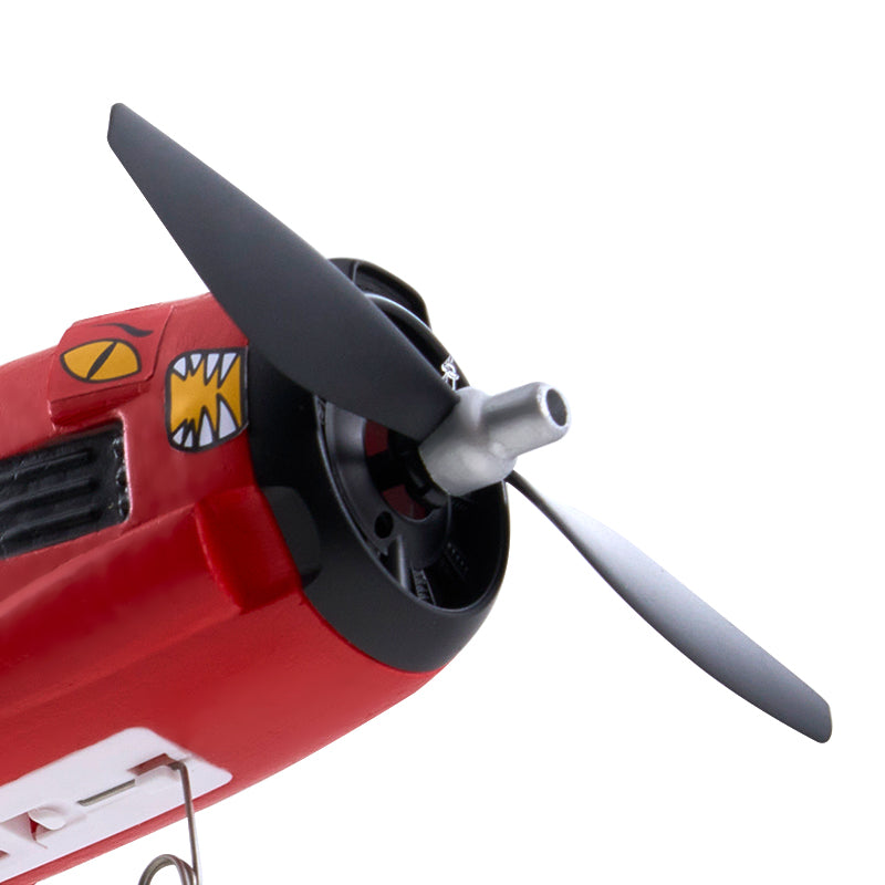Close-up of red FMS 410mm T-28 Trojan RC plane's front propeller and nose art.
