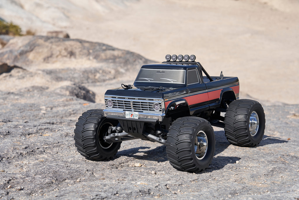 Black RC truck on rugged landscape