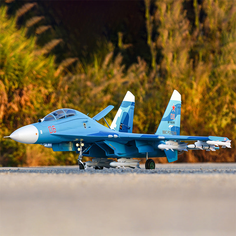 FMS Twin 70mm EDF SU-27 PNP RC jet model, blue with white accents, armed with missiles under wings, on pavement