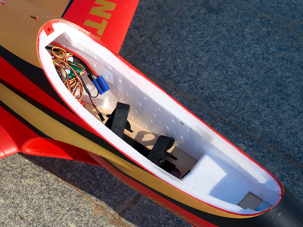 Inside view of an RC jet plane fuselage showing electronics and battery compartment.