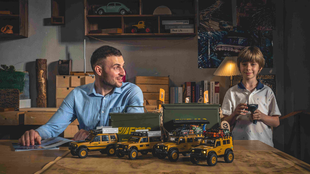 Father and son with RC Camel Trophy Land Rovers.
