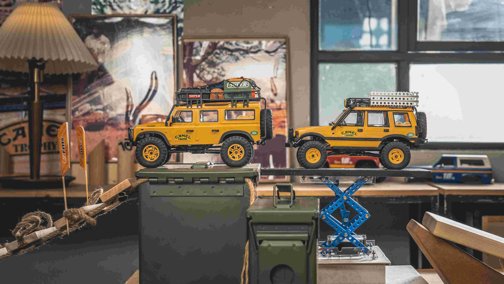 RC Land Rovers on obstacle course.