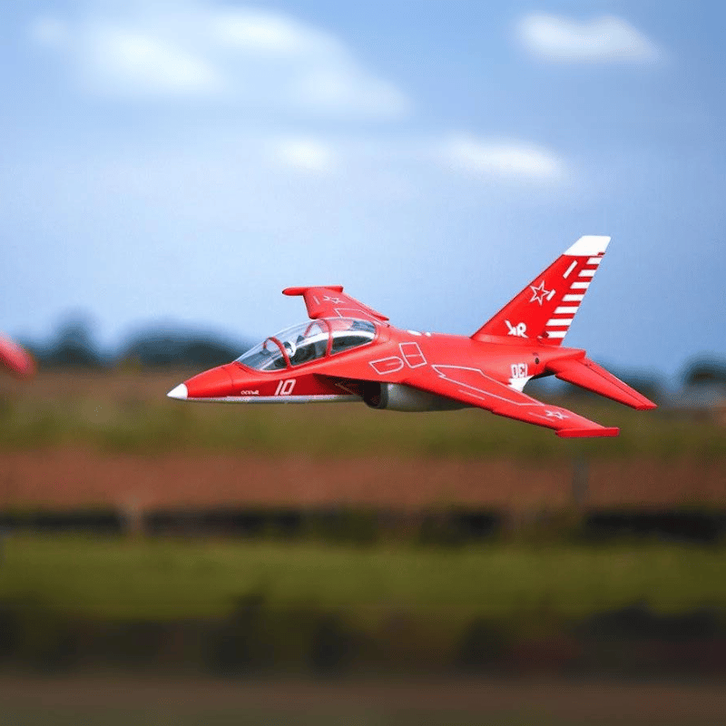 FMS Yak-130 V2 PNP jet model in red, airborne with white accents and '10' marking.