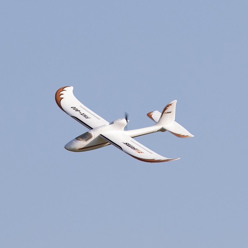 FMS Easy Trainer RTF flying in blue sky, showcasing white and orange design