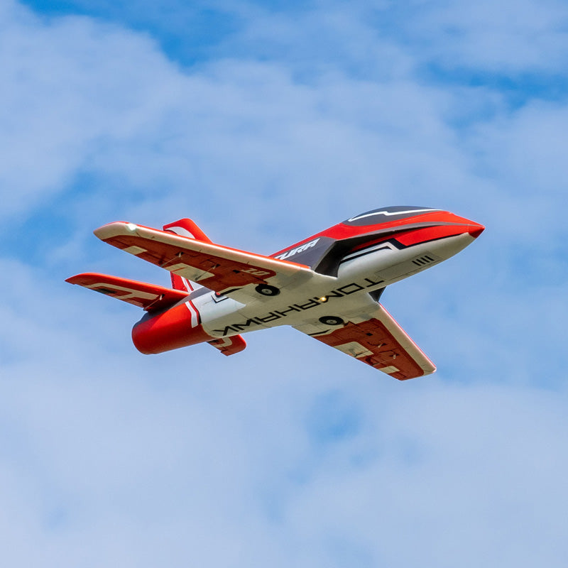 FMS Futura V3 EDF jet soaring in the sky with vibrant red-gray colors.
