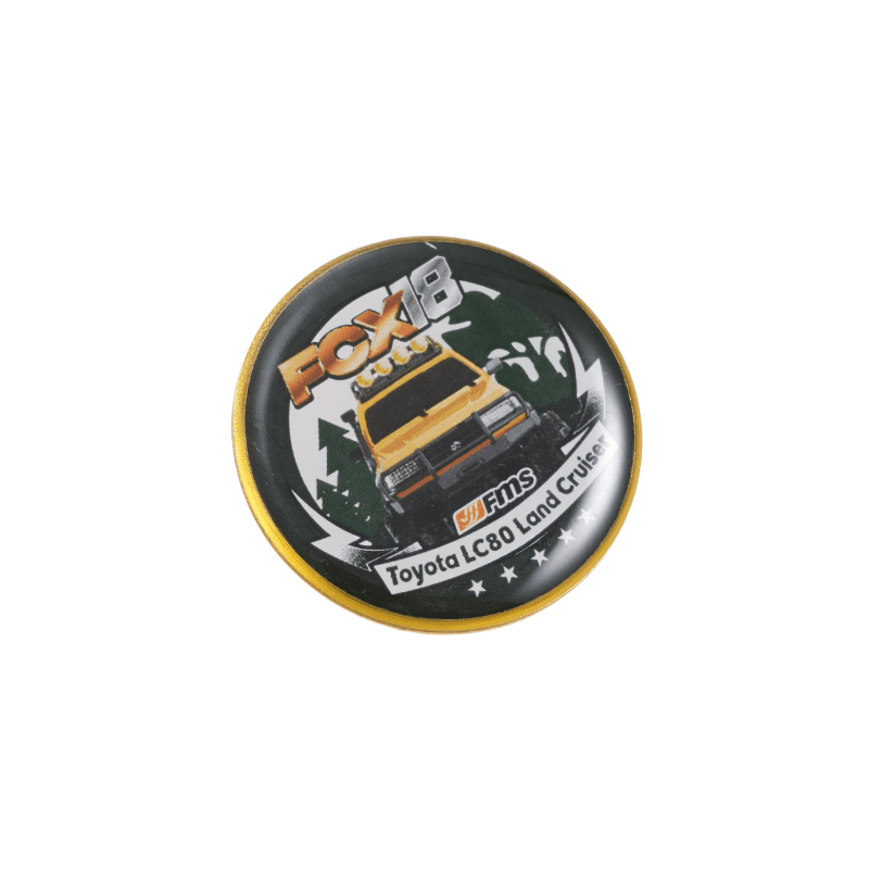 Metal pin showcasing a yellow Toyota LC80 Land Cruiser with FOX branding