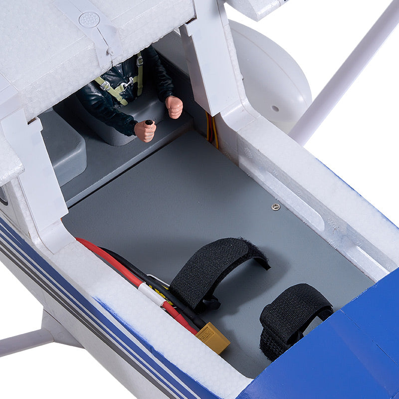 FMS 1500mm Cessna 182 interior showing pilot figure, battery straps, and wiring