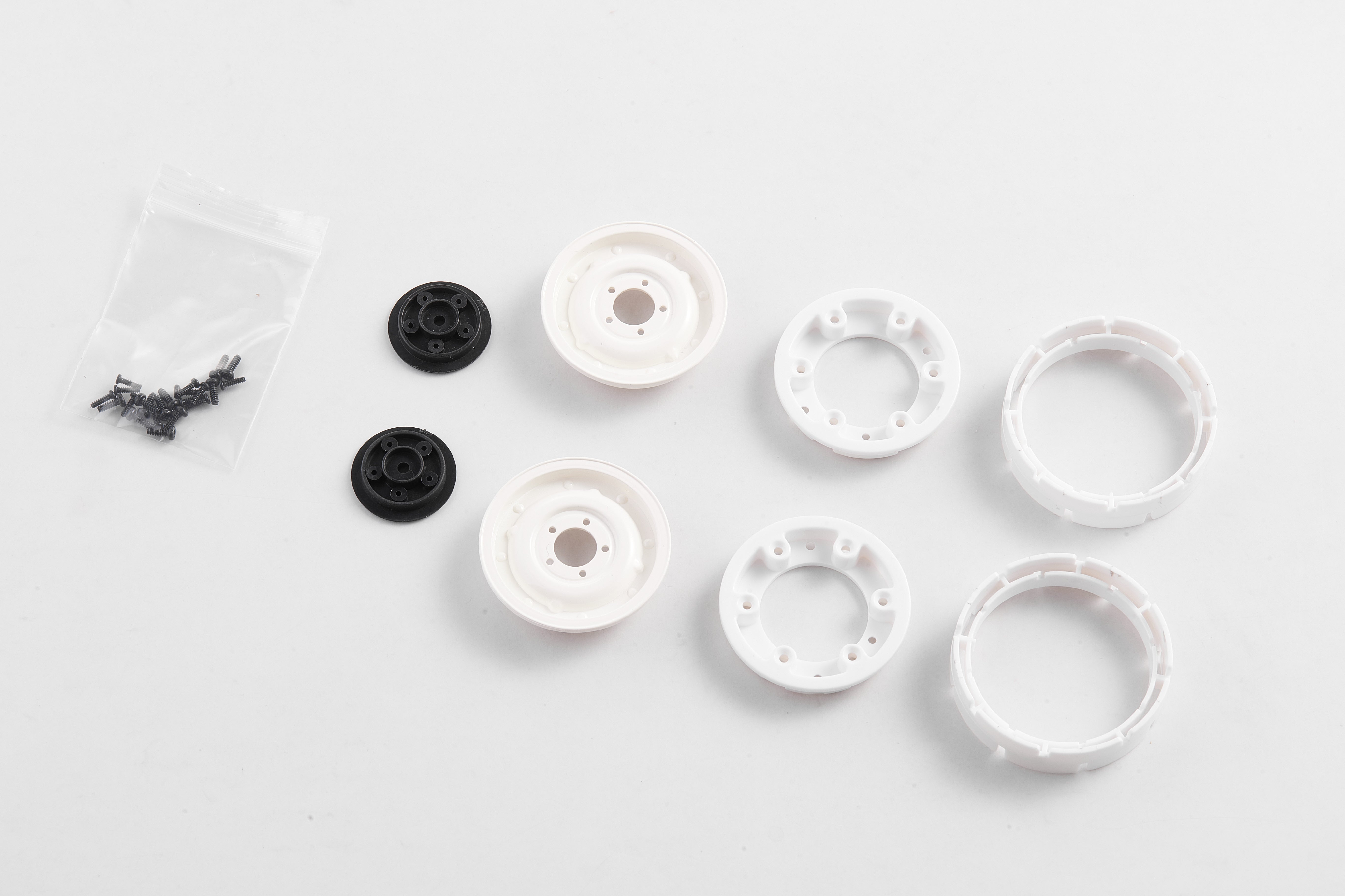1:12 Land Rover wheel set with white rims, black adapters, and screws