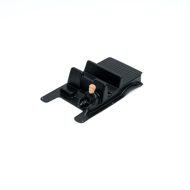 FCX24M RC model black seat compartment with figure for vehicle upgrades.
