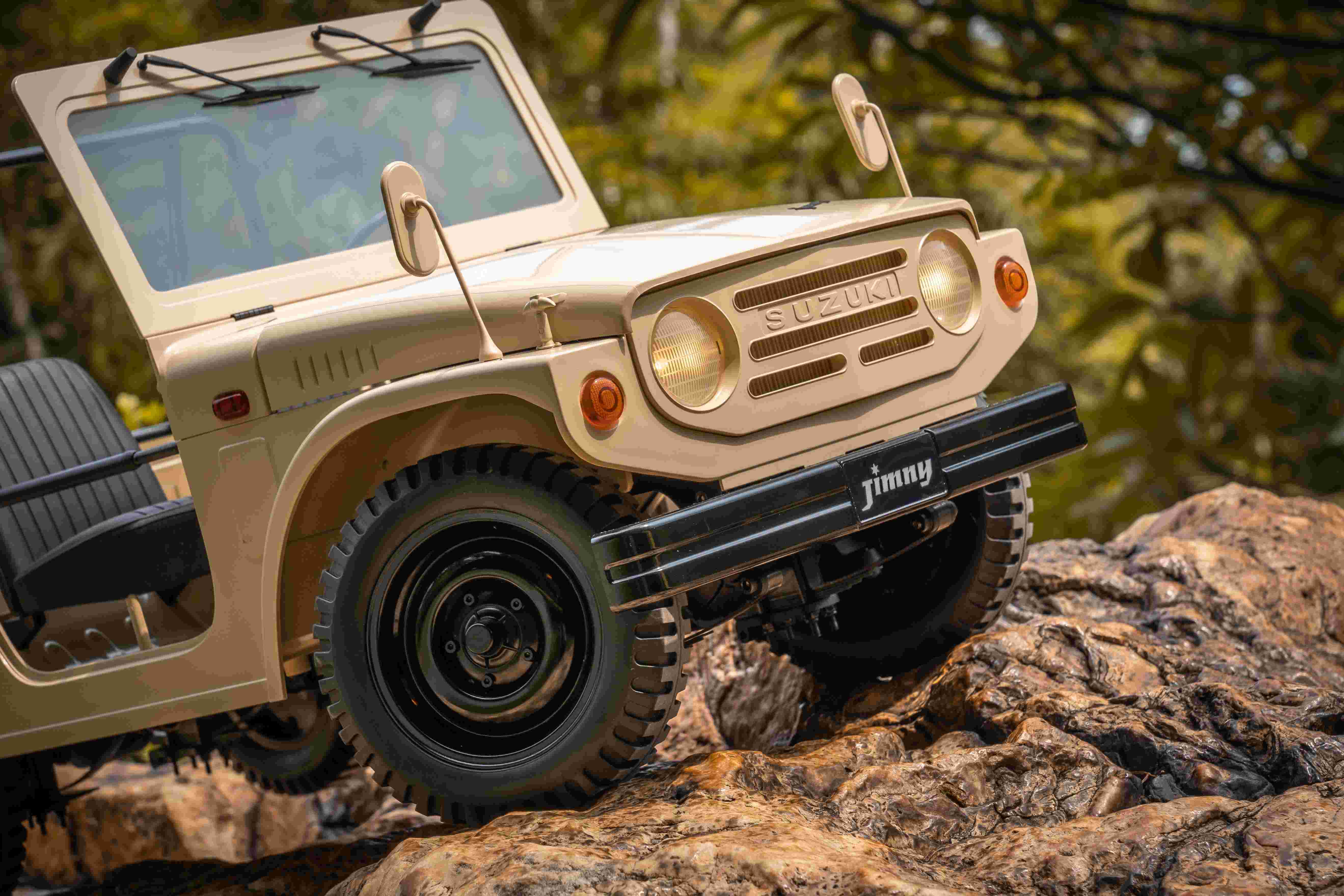 FMS 1:6 scale brown Suzuki Jimny RC car with detailed exterior and off-road tires climbing rocky terrain.