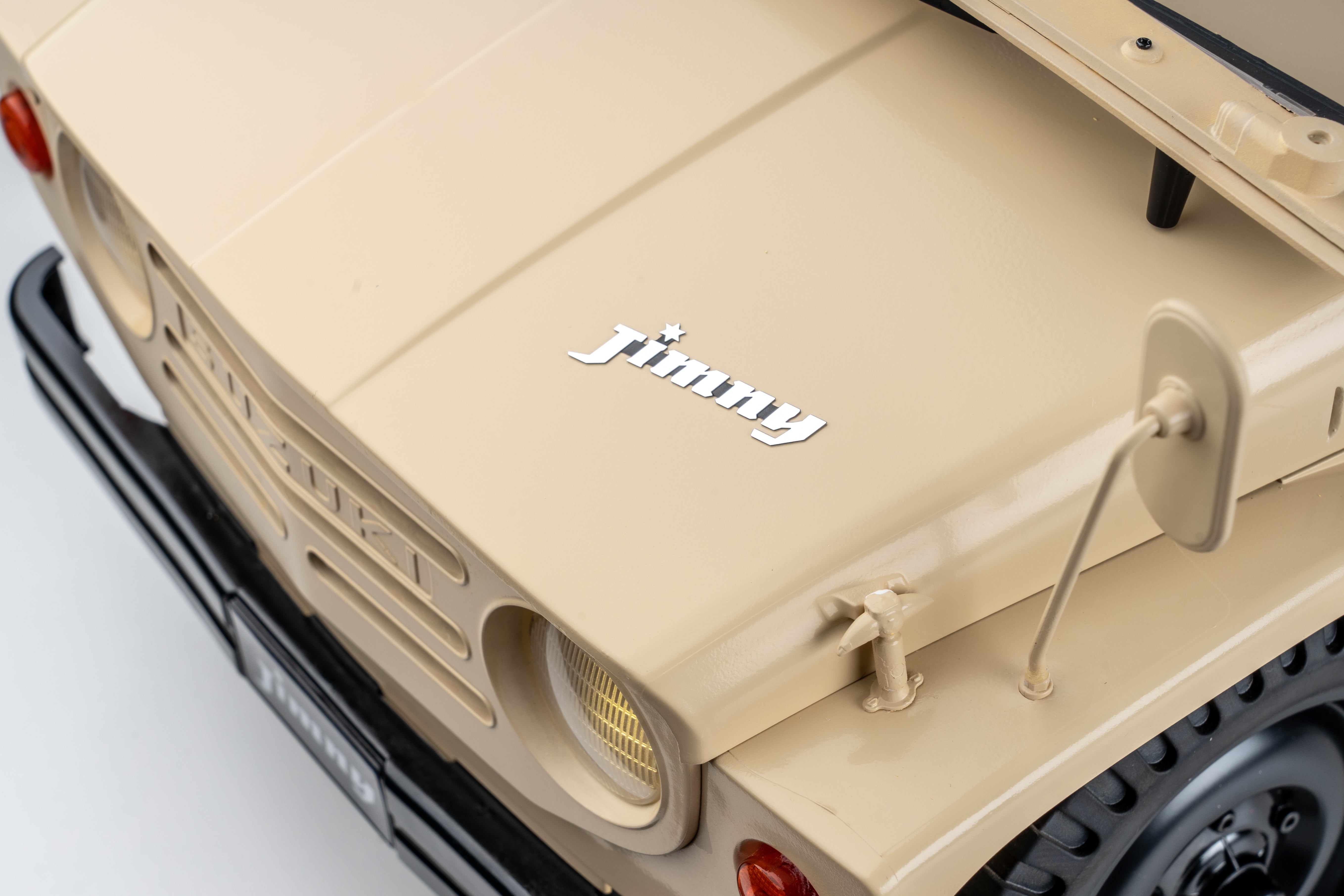 FMS 1:6 scale RC Jimny RS in brown, showing the front hood with the chrome "Jimny" logo.