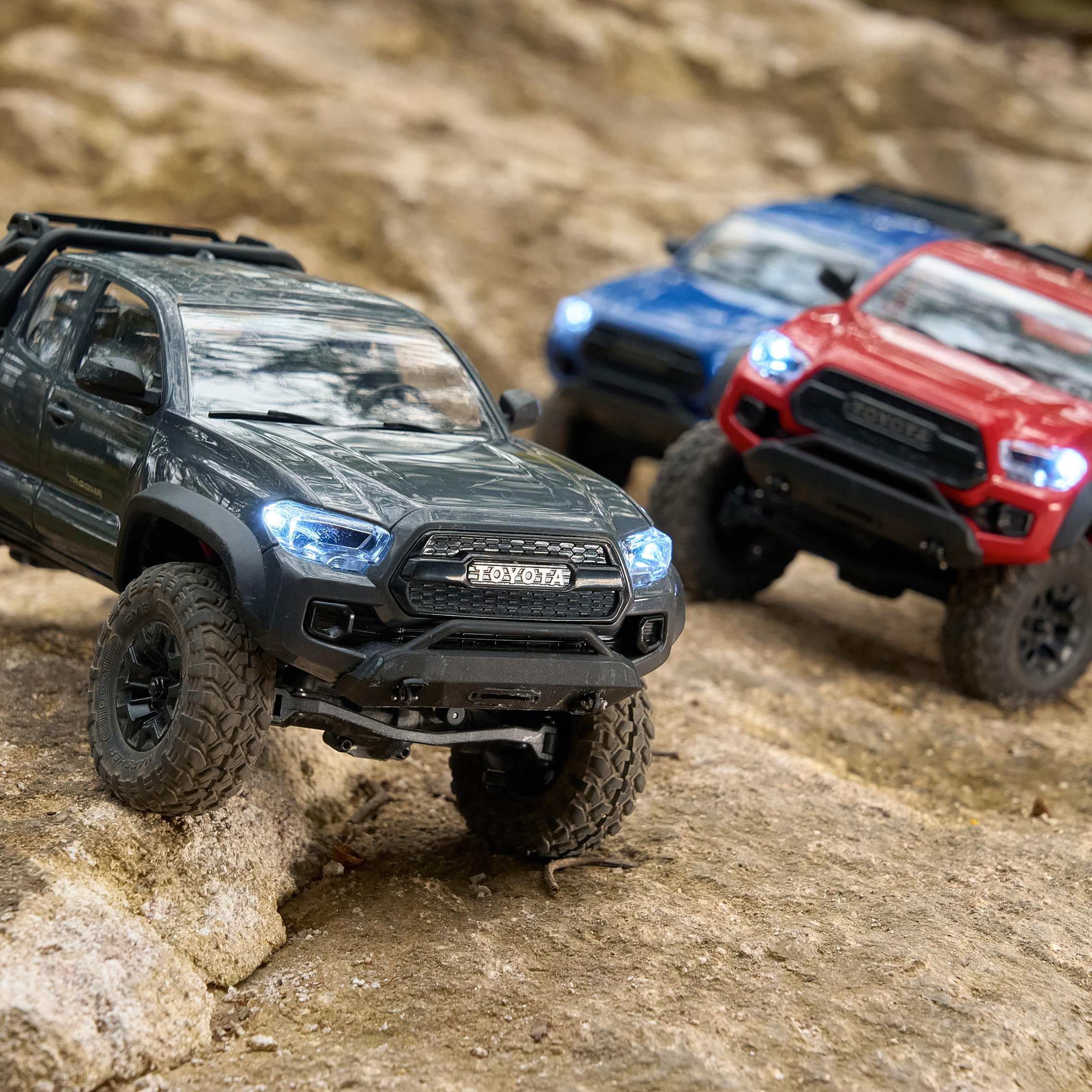 Remote-controlled Toyota-branded off-road crawler truck in black.