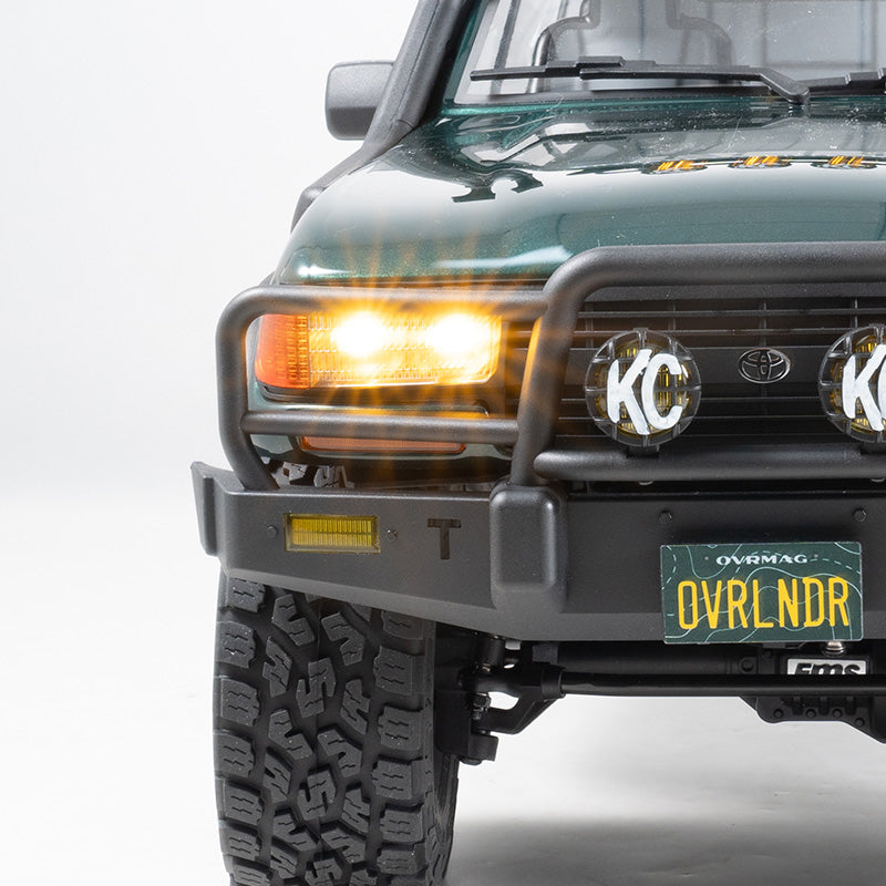 FMS 1:10 FCX10 OVR LC80 RS Brushless RC crawler, green, with bull bar, KC lights, and OVRLNDR plate.