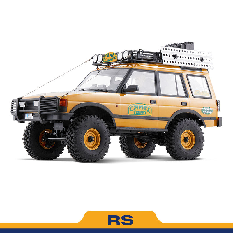 FMS 1:10 FCX10 Land Rover Camel Trophy RS model: yellow SUV with roof rack and off-road tires.