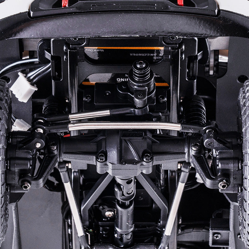 Underside view of 1:18 GMC Sierra S RC truck chassis with metal suspension and drivetrain.